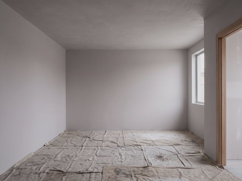 Repaired ceiling in a residential room with drop sheets still down
