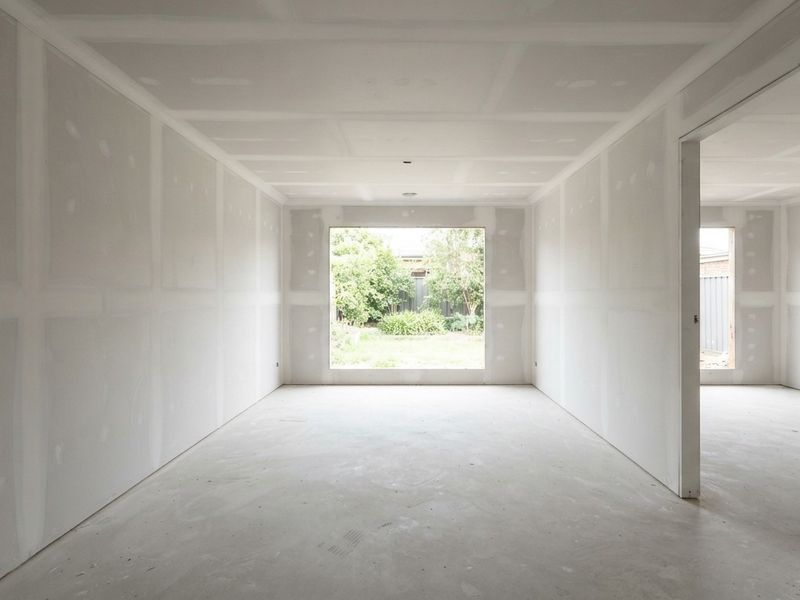 Residential room sheeted in plasterboard, joints set and sanded ready for the painter