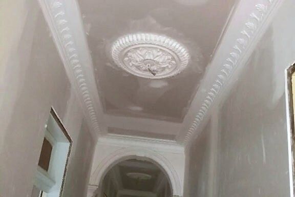 Ornate plaster ceiling rose above a restored archway in a Sydney terrace