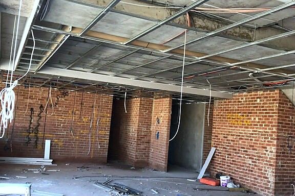 Brick shell with exposed slab and services before plastering