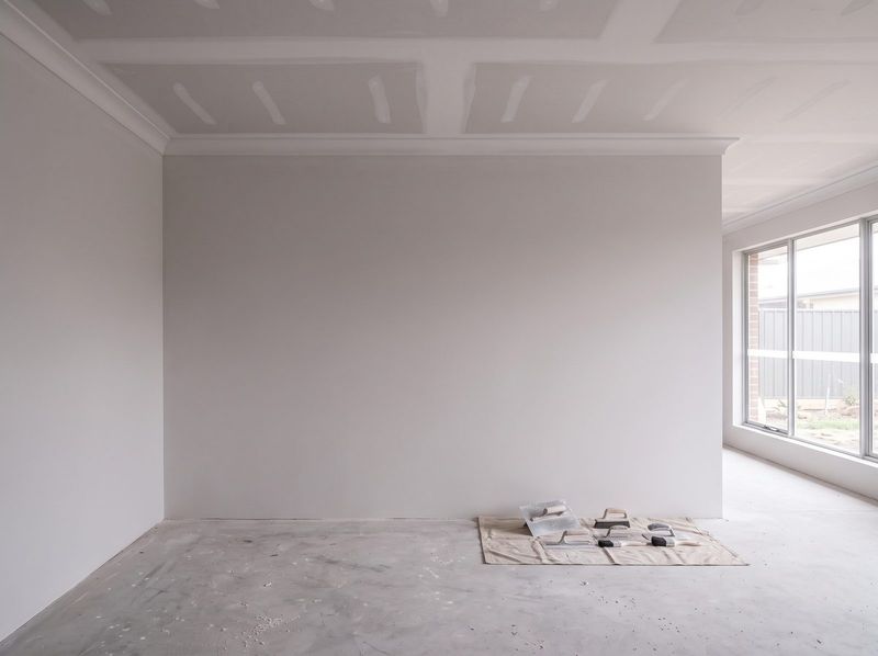 Wall skimmed and set smooth in a residential room with floors covered