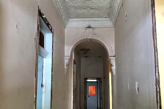 Restored heritage hallway with ornate pressed ceiling and cornice