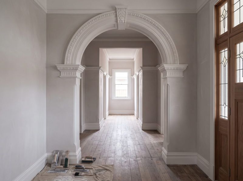 Restored plaster archway with decorative moulding in a Federation era hallway